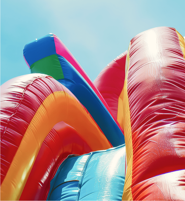 A large inflatable slide set against a clear blue sky, inviting fun and excitement for all ages